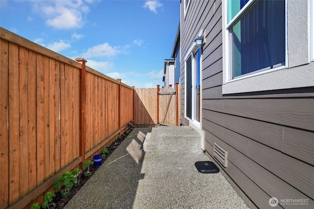 view of side of property featuring fence and a patio