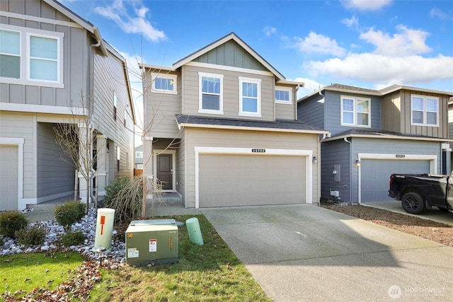 view of front facade with board and batten siding, an attached garage, and concrete driveway