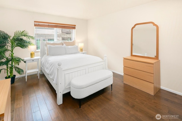 bedroom featuring dark wood finished floors and baseboards