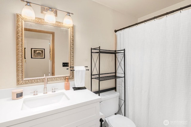 bathroom with toilet, a shower with shower curtain, and vanity