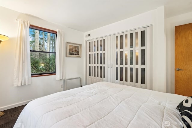 10209 Edgewood Dr, Anderson Island, WA 98303 - bedroom featuring baseboards, visible vents, and wood finished floors