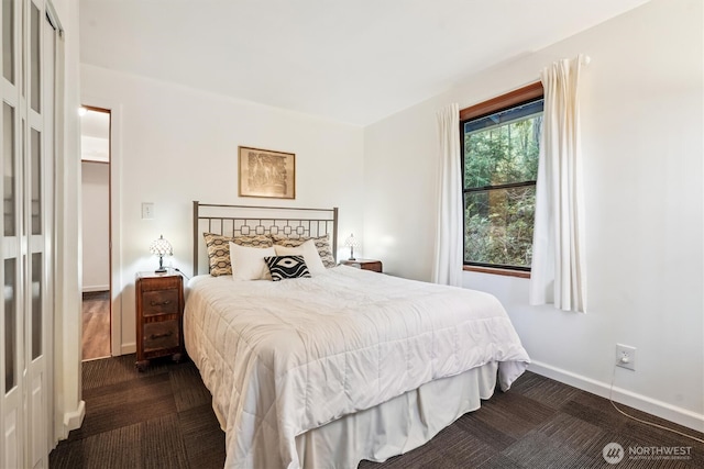 10209 Edgewood Dr, Anderson Island, WA 98303 - bedroom featuring baseboards and dark colored carpet