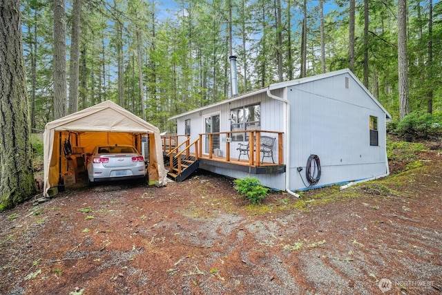10209 Edgewood Dr, Anderson Island, WA 98303 - view of side of property featuring dirt driveway and a wooden deck