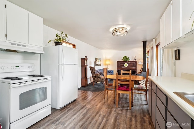10209 Edgewood Dr, Anderson Island, WA 98303 - kitchen with dark wood finished floors, light countertops, white cabinets, white appliances, and under cabinet range hood
