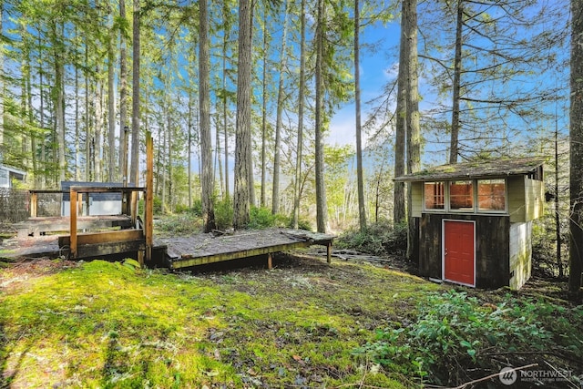 10209 Edgewood Dr, Anderson Island, WA 98303 - view of yard featuring an outdoor structure, a wooden deck, and a storage shed