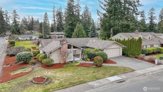 view of front of property with a garage, driveway, a front yard, and a residential view