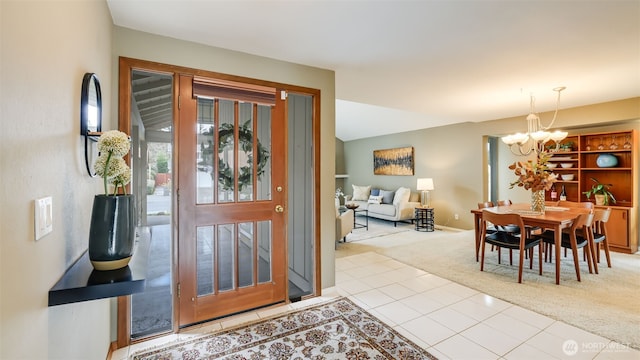 carpeted entrance foyer with a chandelier and tile patterned flooring