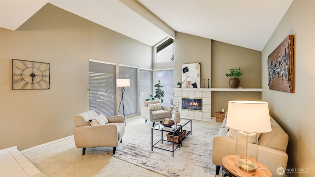 carpeted living area featuring baseboards, beam ceiling, high vaulted ceiling, and a tiled fireplace