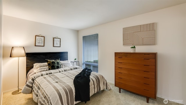 carpeted bedroom featuring baseboards