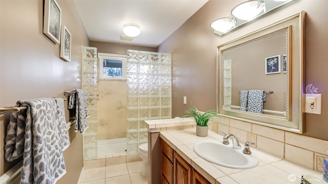 full bathroom featuring visible vents, toilet, vanity, a walk in shower, and tile patterned floors