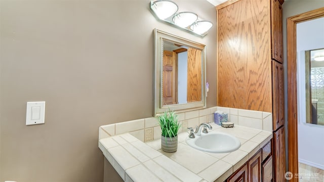 bathroom featuring tasteful backsplash and vanity