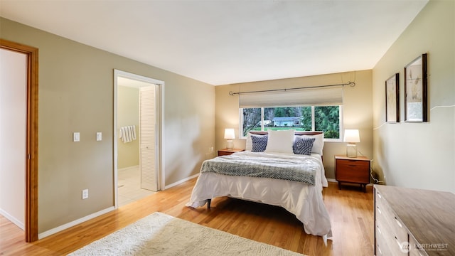 bedroom featuring light wood-style floors and baseboards