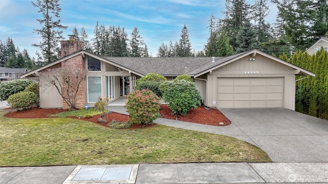 view of front of home with an attached garage, a shingled roof, driveway, a chimney, and a front yard