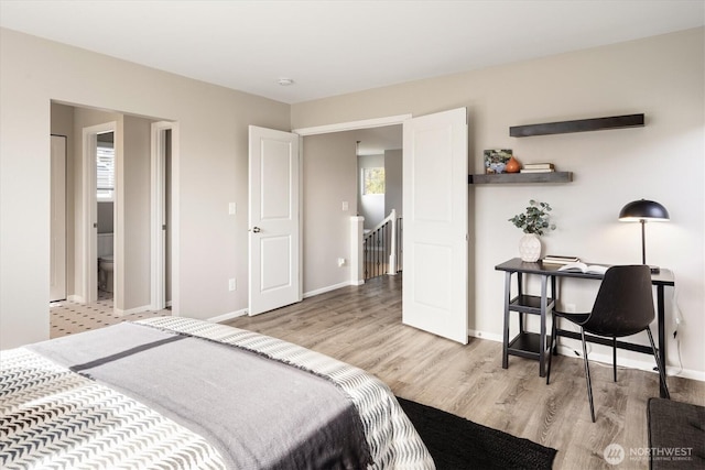 bedroom featuring wood finished floors and baseboards