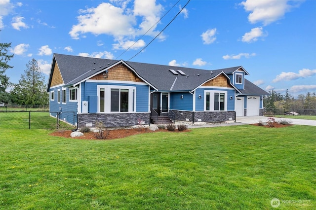 craftsman inspired home with a front yard, concrete driveway, and fence