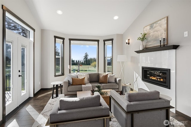 living area with lofted ceiling, french doors, and a wealth of natural light