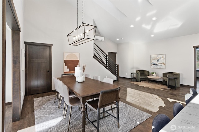 dining space featuring high vaulted ceiling, recessed lighting, wood finished floors, baseboards, and stairs