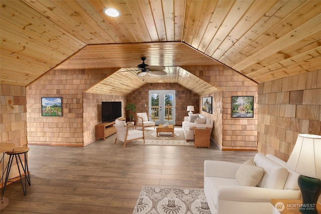 interior space with lofted ceiling, wooden ceiling, a ceiling fan, and wood finished floors