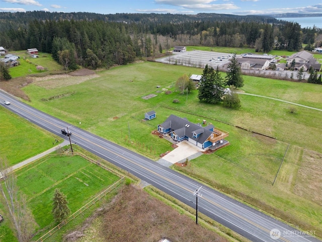 bird's eye view featuring a rural view and a wooded view