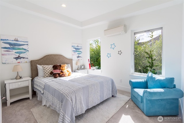 carpeted bedroom with a wall unit AC and baseboards