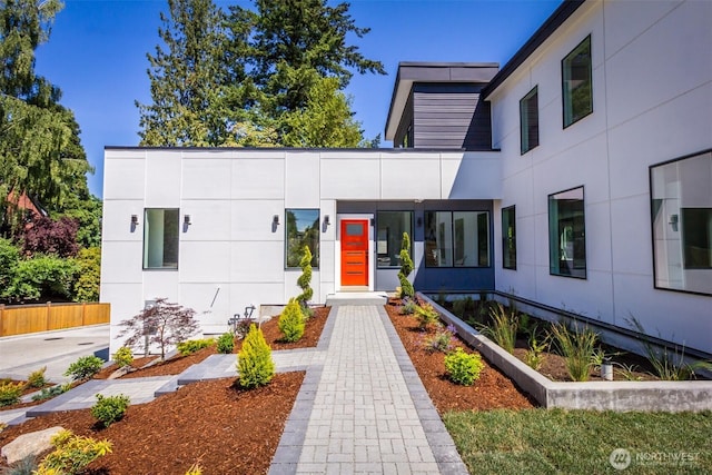 entrance to property featuring stucco siding