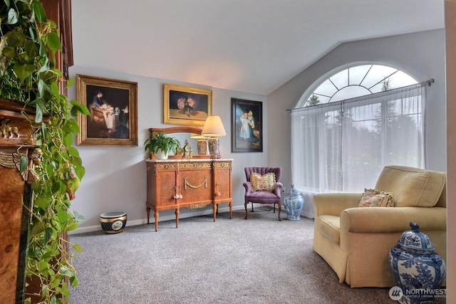 living area featuring carpet floors, vaulted ceiling, and baseboards