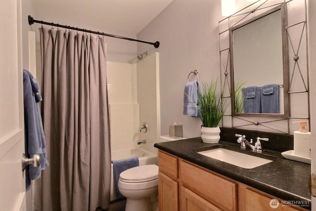 full bath featuring toilet, shower / bath combo with shower curtain, and vanity