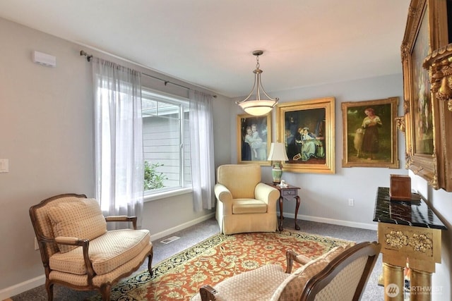 living area with carpet flooring, visible vents, and baseboards