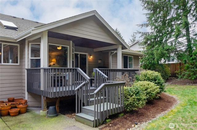 exterior space featuring a shingled roof and fence