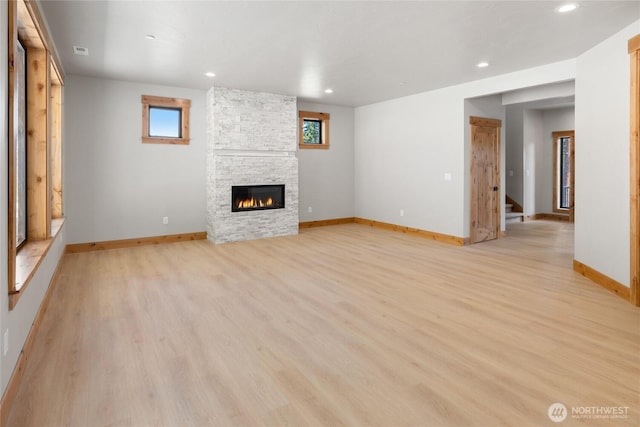 660 Stone Ridge Dr, Cle Elum, WA 98922 - unfurnished living room with baseboards, stairway, light wood-type flooring, a fireplace, and recessed lighting