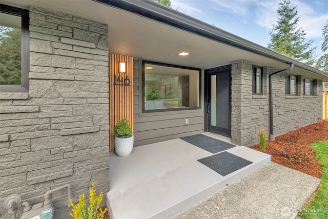 view of exterior entry featuring stone siding