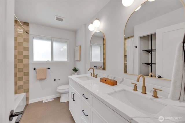 bathroom featuring toilet, tile patterned flooring, a sink, and visible vents