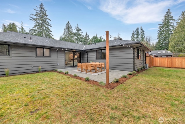 back of property with a lawn, a patio area, and fence