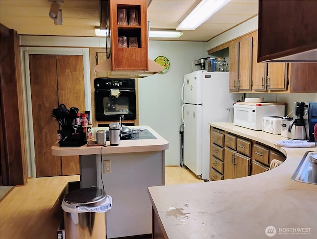 kitchen featuring light countertops and black appliances