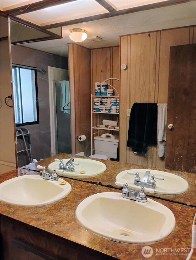 full bathroom with a sink and double vanity