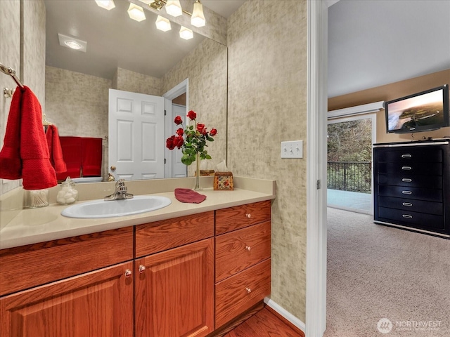 bathroom featuring vanity and wallpapered walls