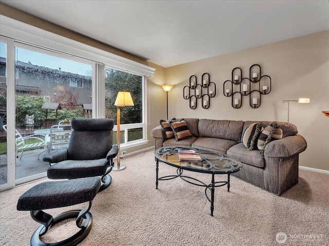 living room featuring carpet flooring and baseboards