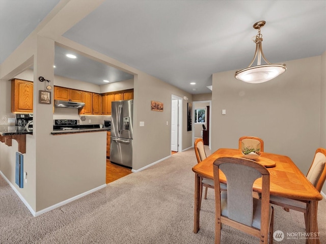 dining room with light carpet, baseboards, and recessed lighting