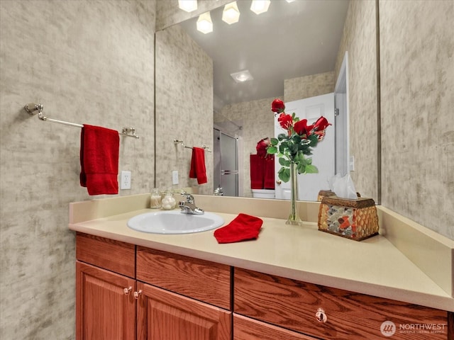 bathroom featuring a stall shower and vanity