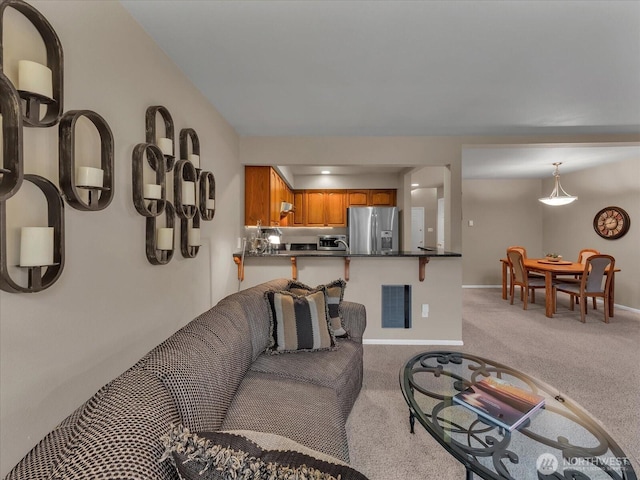 living room featuring light colored carpet, visible vents, and baseboards