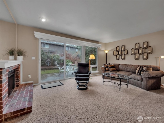 living area featuring carpet, a fireplace, and baseboards