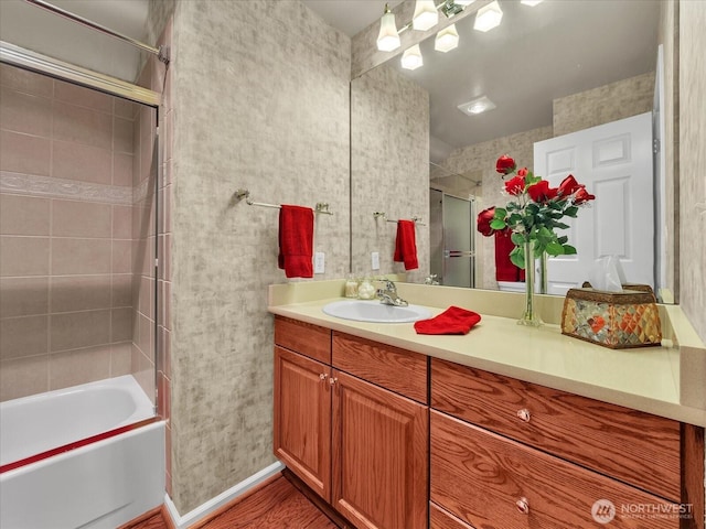 full bath with shower / bath combination, vanity, and baseboards