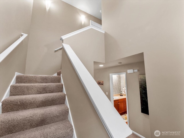 stairs featuring a towering ceiling