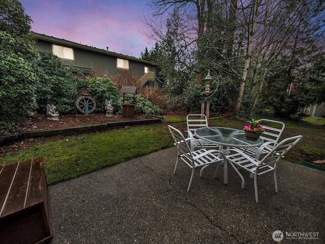 patio terrace at dusk with outdoor dining space