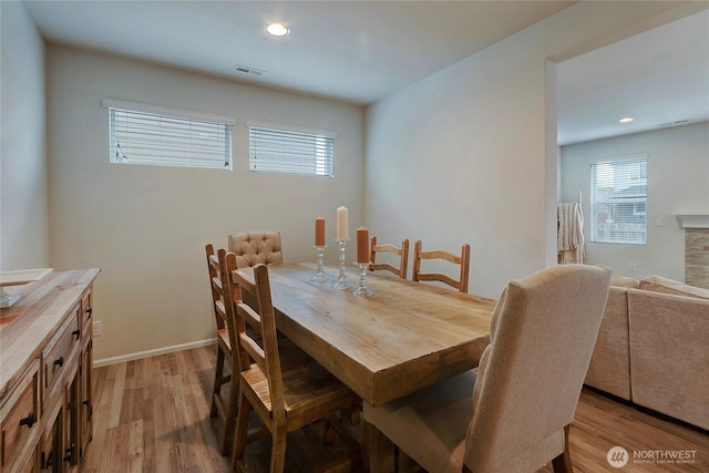 dining area with light wood-style flooring, visible vents, baseboards, and recessed lighting