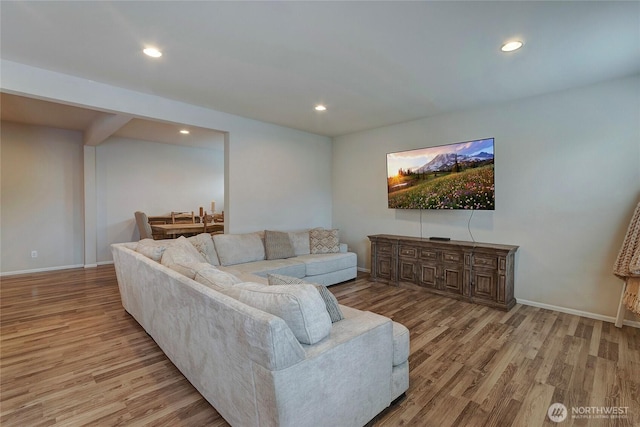 living room featuring recessed lighting, baseboards, and wood finished floors