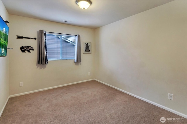 empty room featuring carpet, visible vents, and baseboards