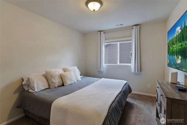 carpeted bedroom with visible vents and baseboards