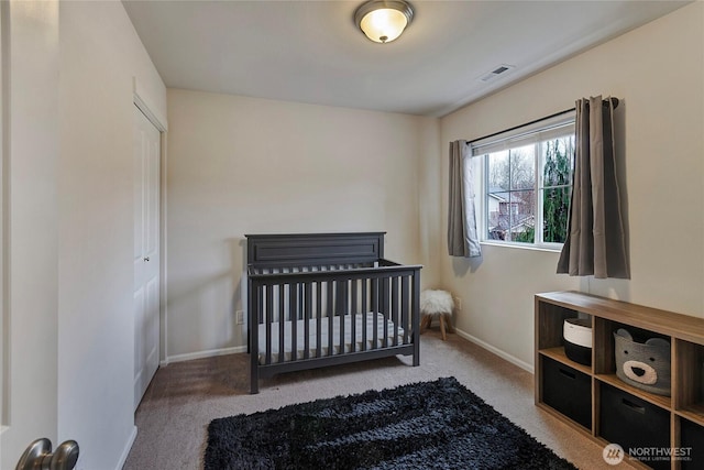 carpeted bedroom featuring visible vents and baseboards