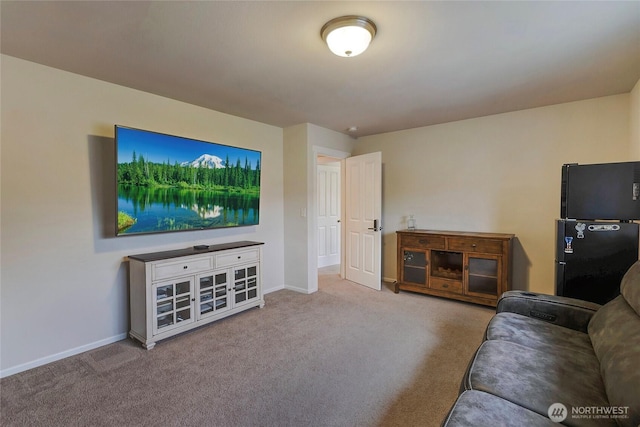 carpeted living area with baseboards